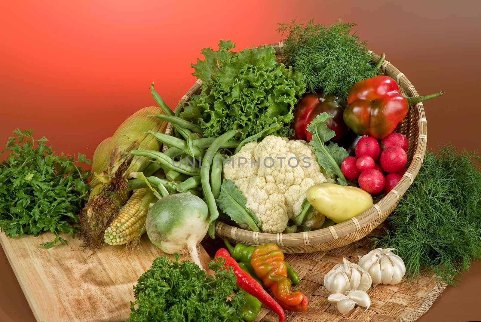 Wicker basket and vegetables on a studio background