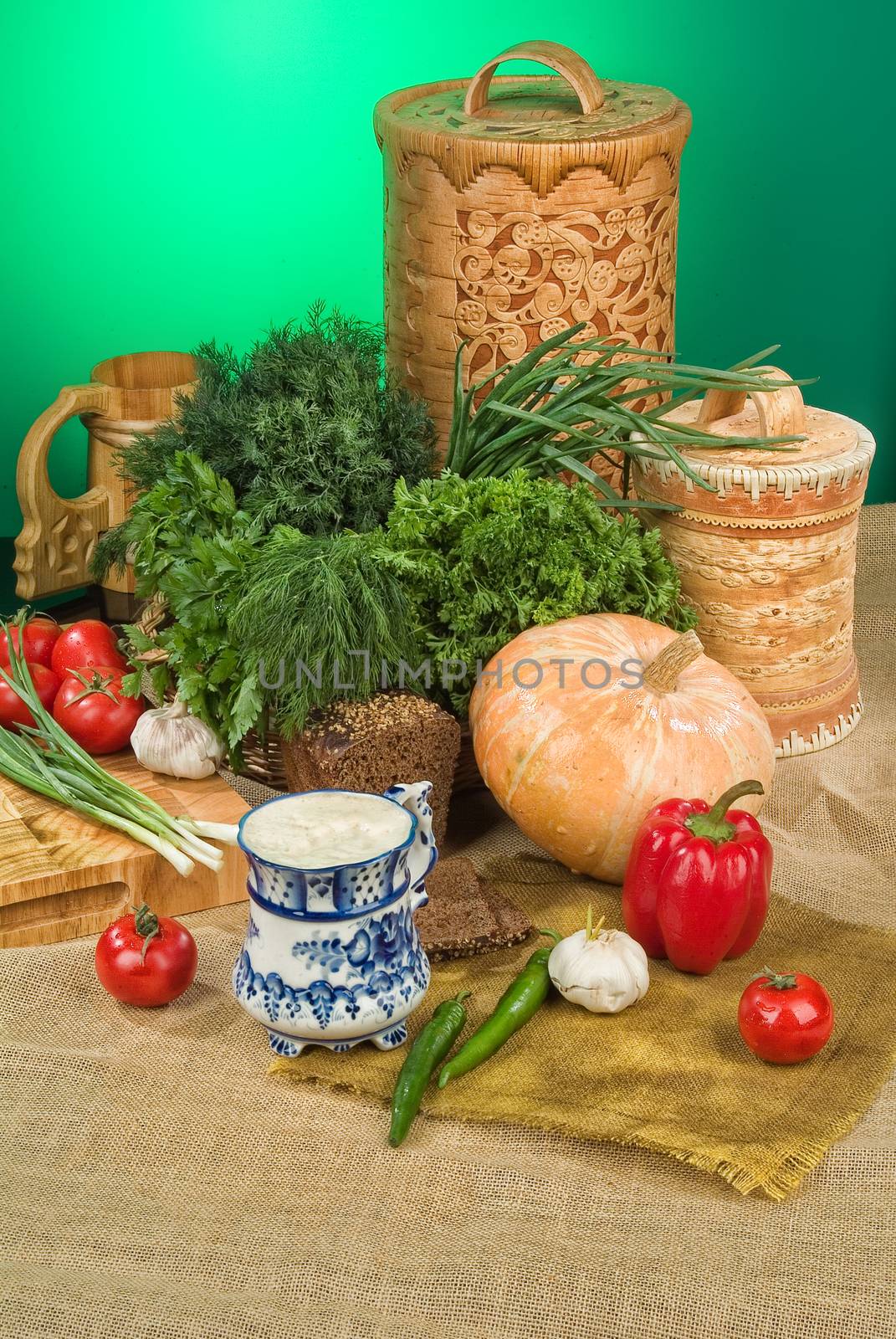 Vegetables, greenery and pumpkin on a studio background