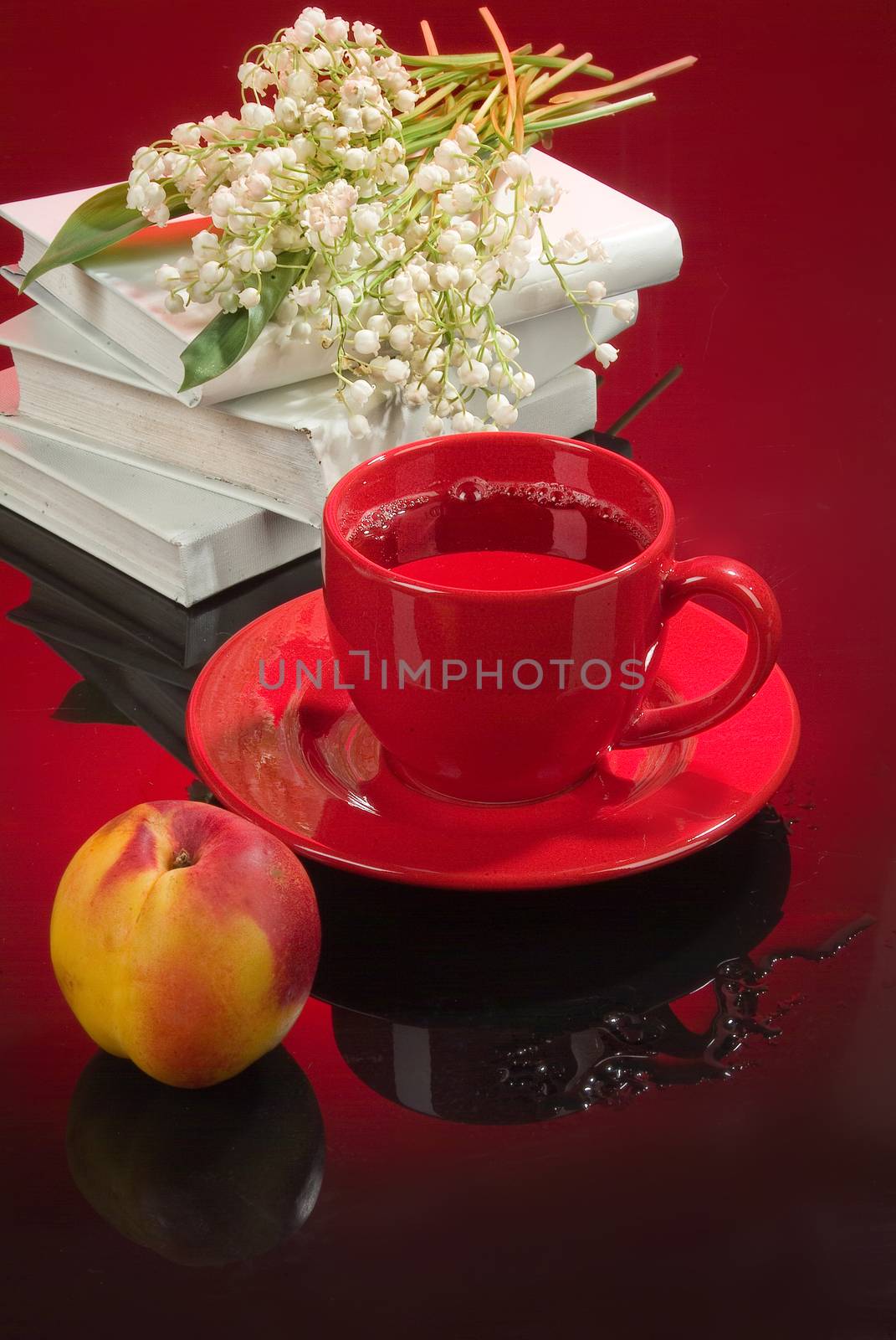 Cup of tea and a bouquet of lilies of the valley