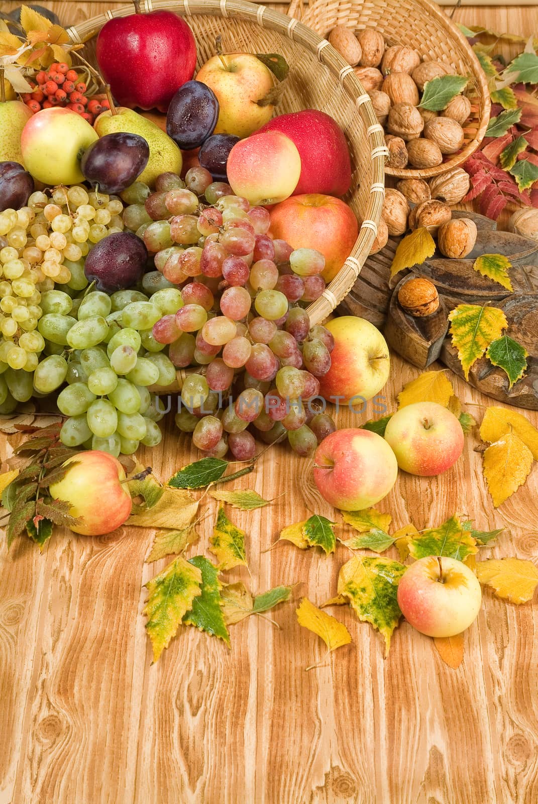 Fruits in a wicker basket on a wooden background