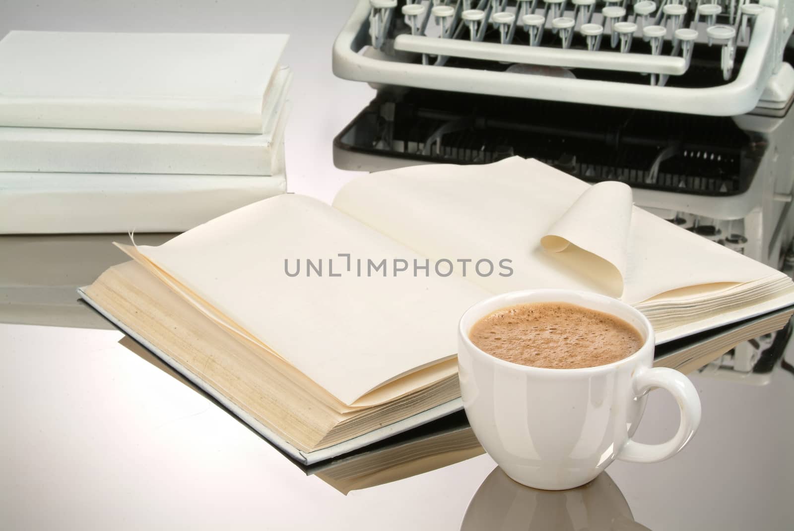 Cup of coffee, books and typewriter on a glass background