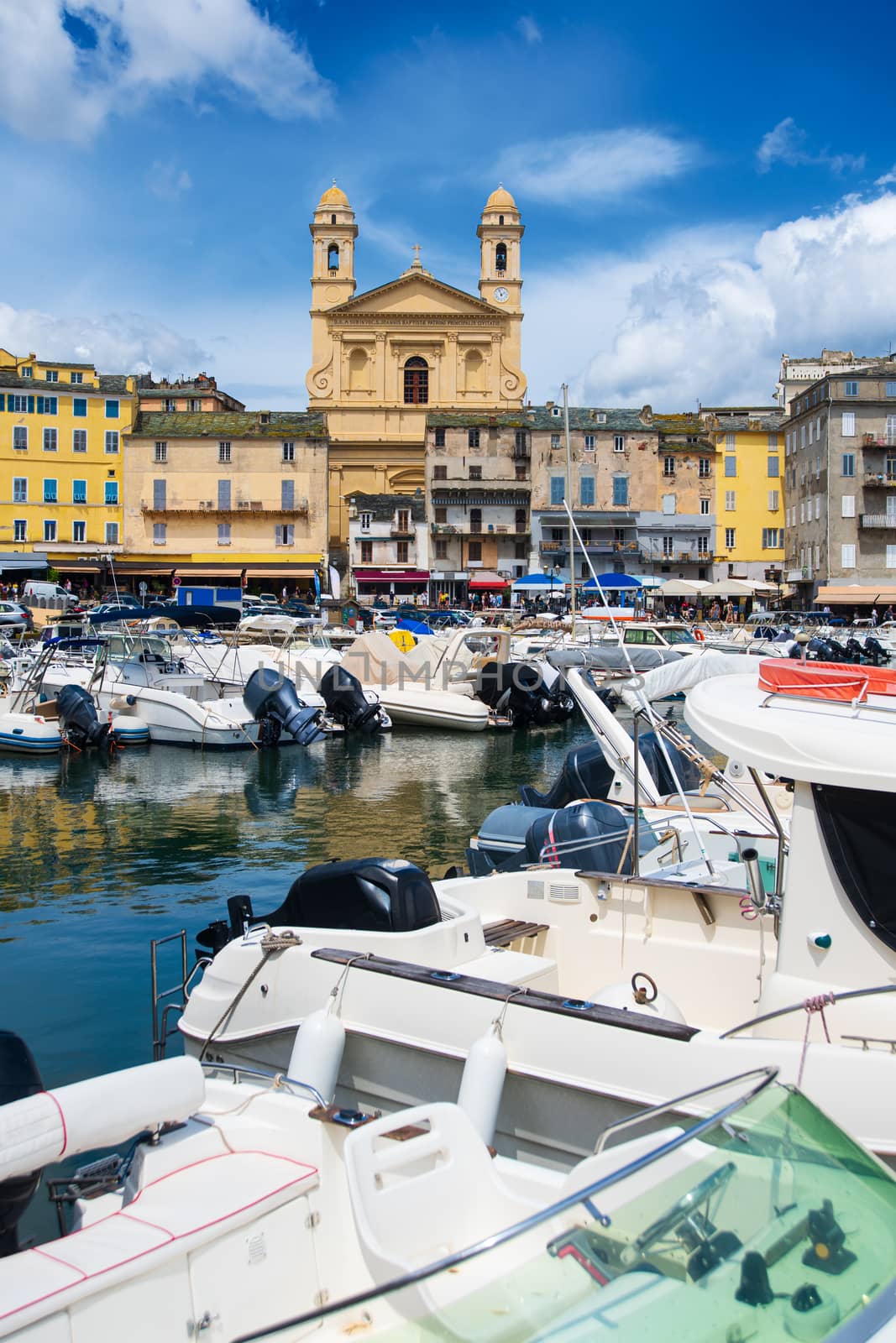 view on église Saint Jean-Baptiste in Bastia from the vieux port with some boats resting in the habour during summertime