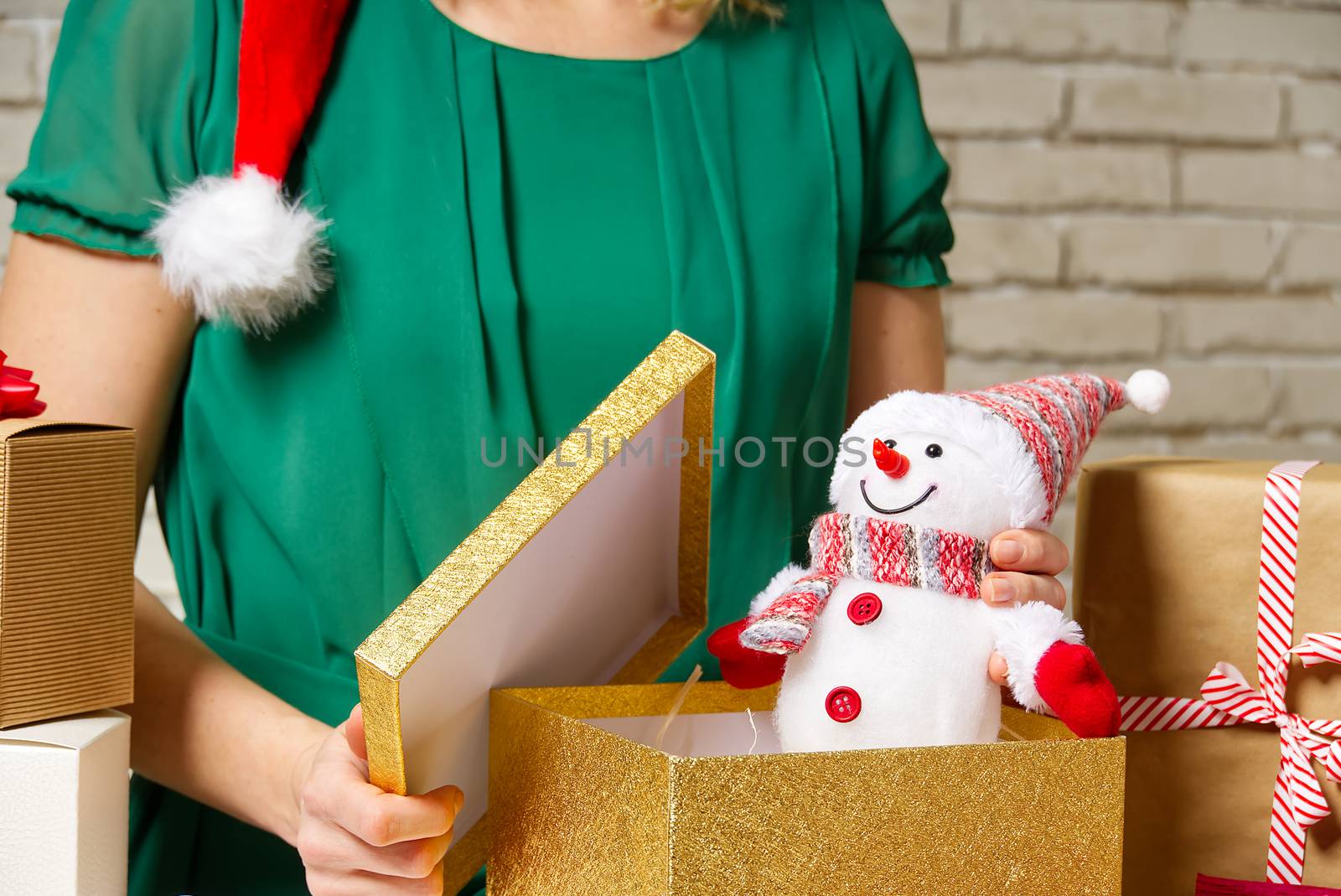 Gift wrapping for Christmas and New Year. Handmade. girl's hands with gift ribbon, twine, tape and present wrapped and packing concept