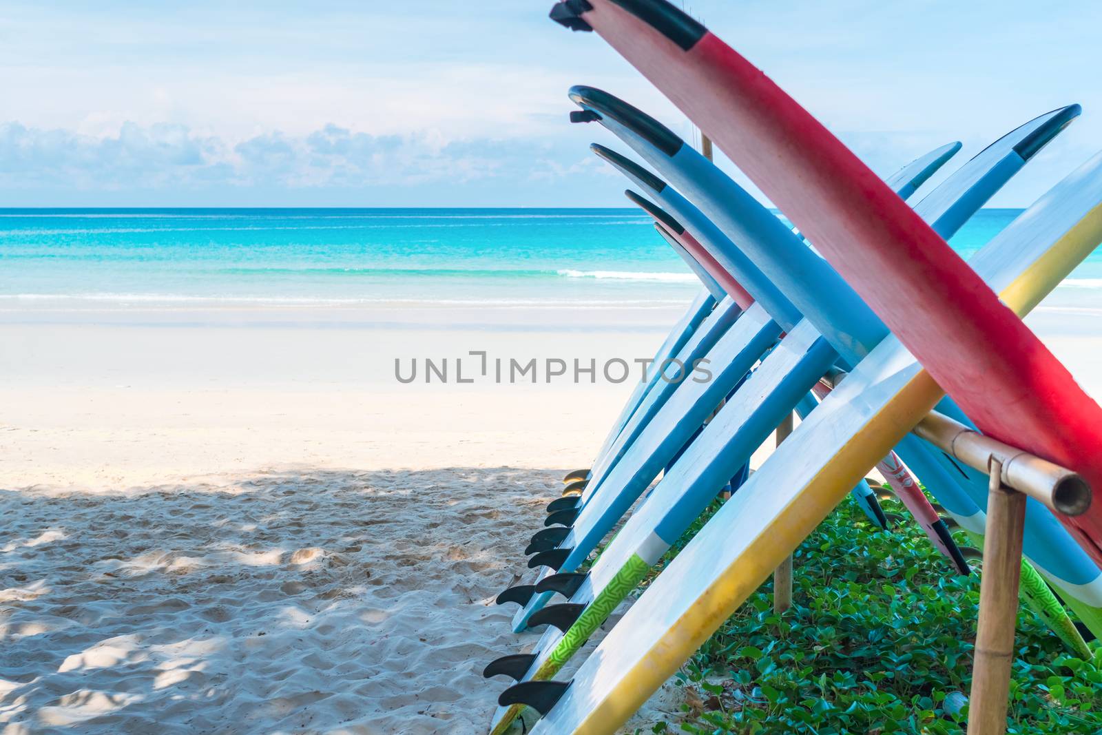 Many surfboards for rent  at summer beach with sunlight  blue sky background. 