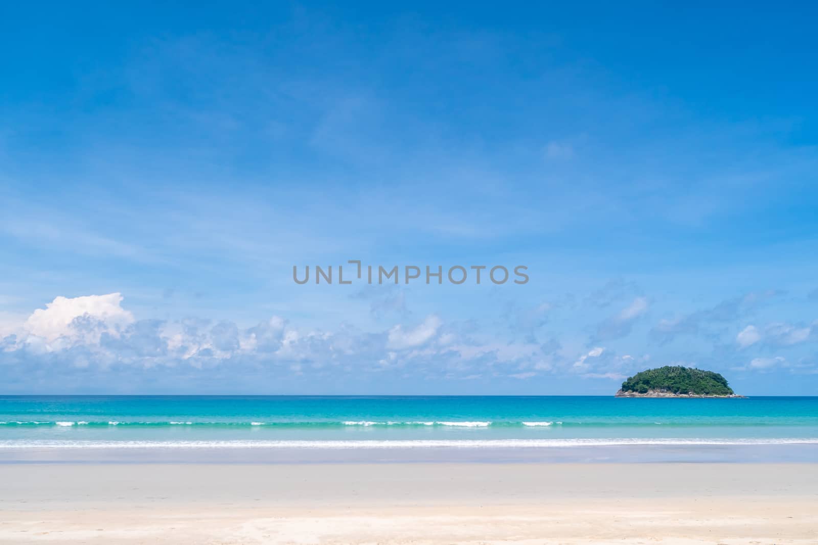 Tropical nature clean beach and white sand in summer season with sun light blue sky background.