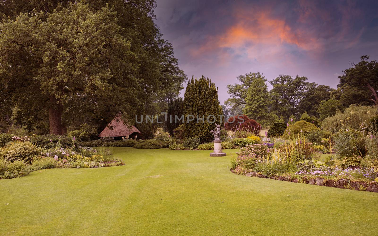 big green gardenwith ngreen grass flowers and gardenhouse