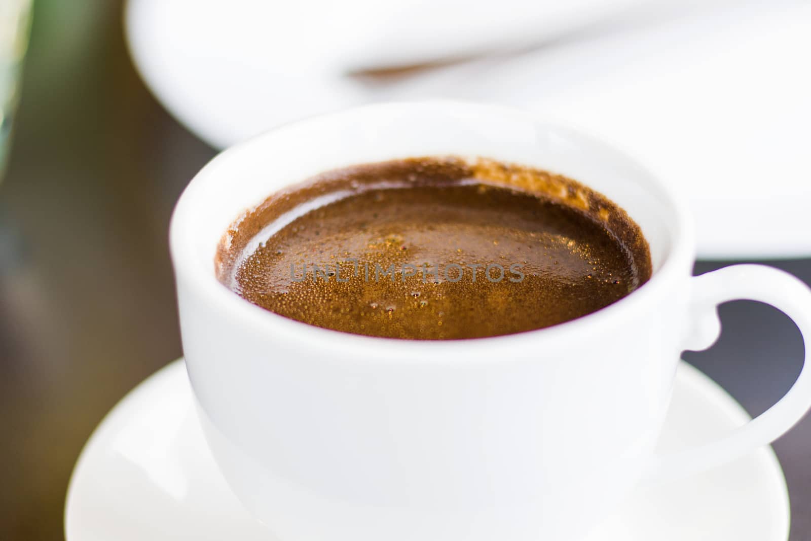 Turkish cup pf coffee, dark coffee close-up and macro, hot aromatic drink in white cup