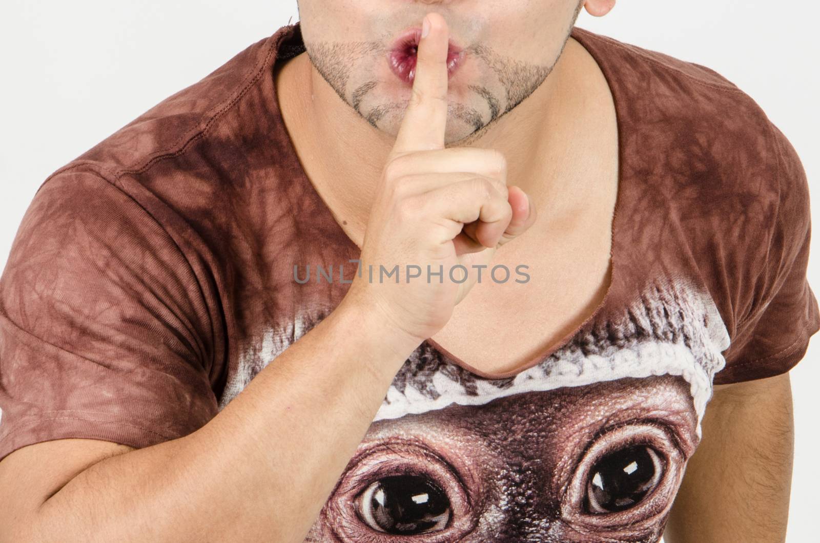 Finger on lips as man gesturing sign shh, please, silence concept, white background.