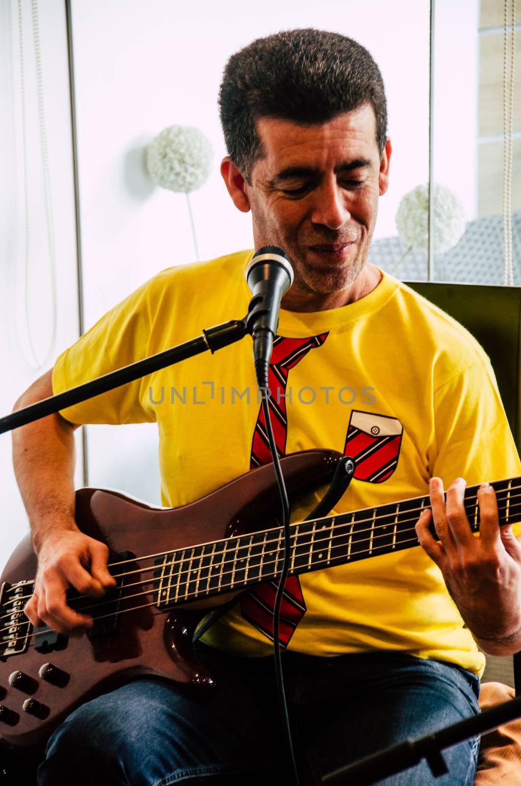 Handsome young musician playing the guitar and singing