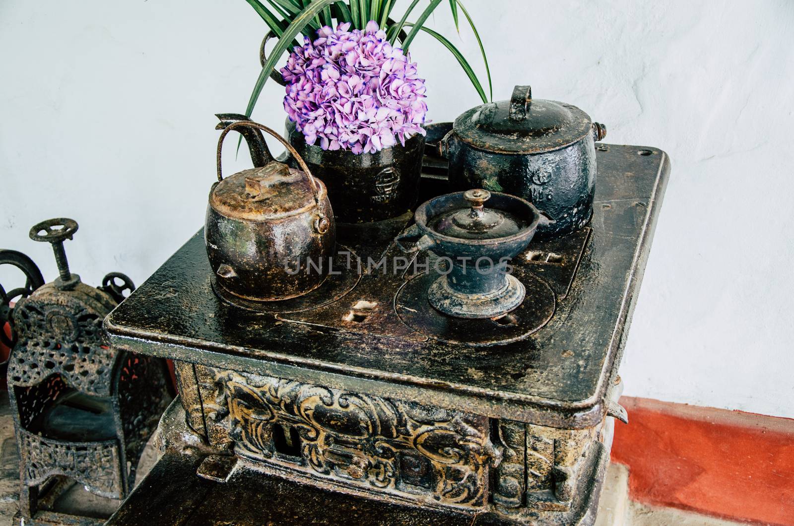 Old vintage kitchen with pots and teapots with flowers, concept of decoration
