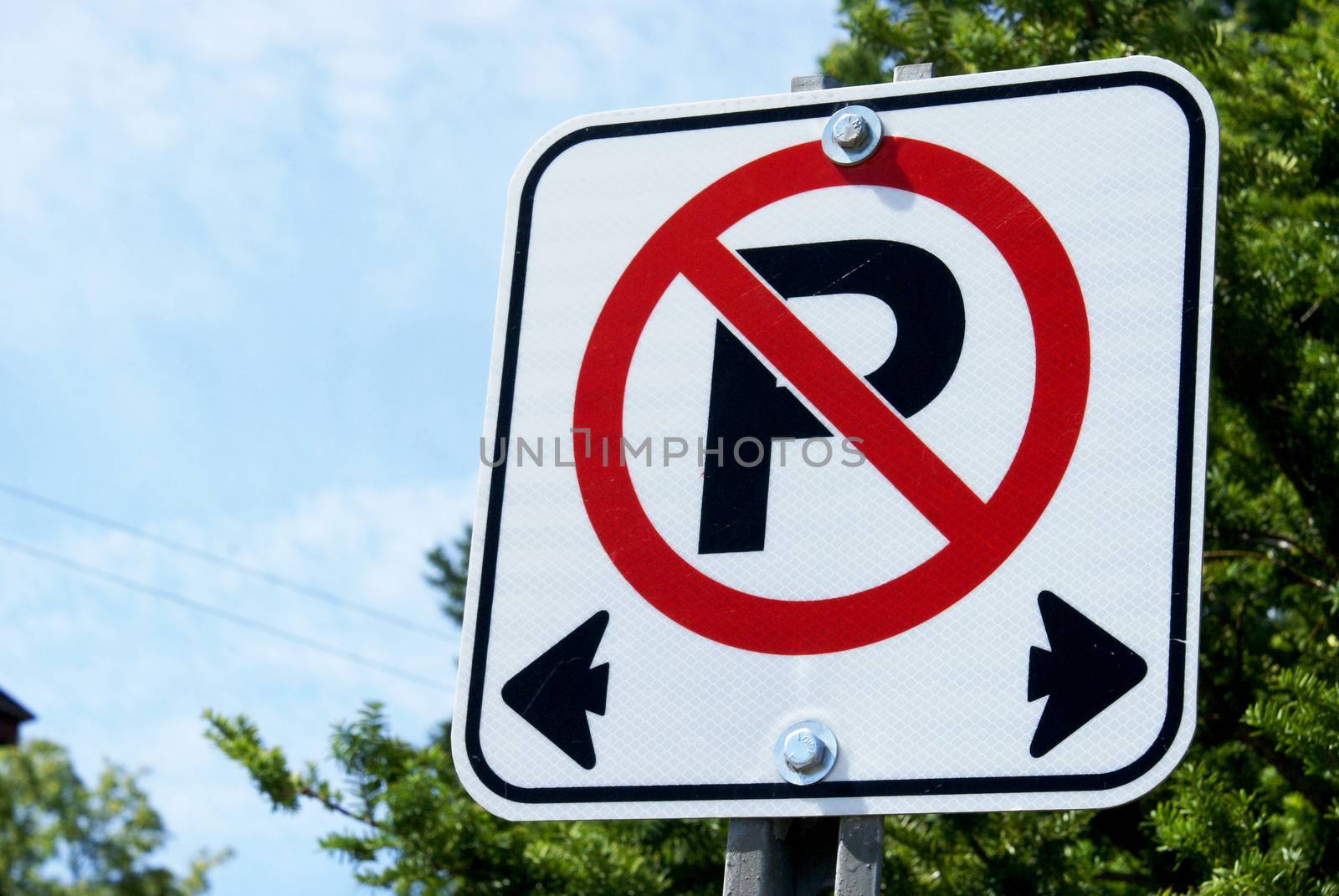 A horizontal closeup image focused on a no parking sign used in Canadian traffic laws.