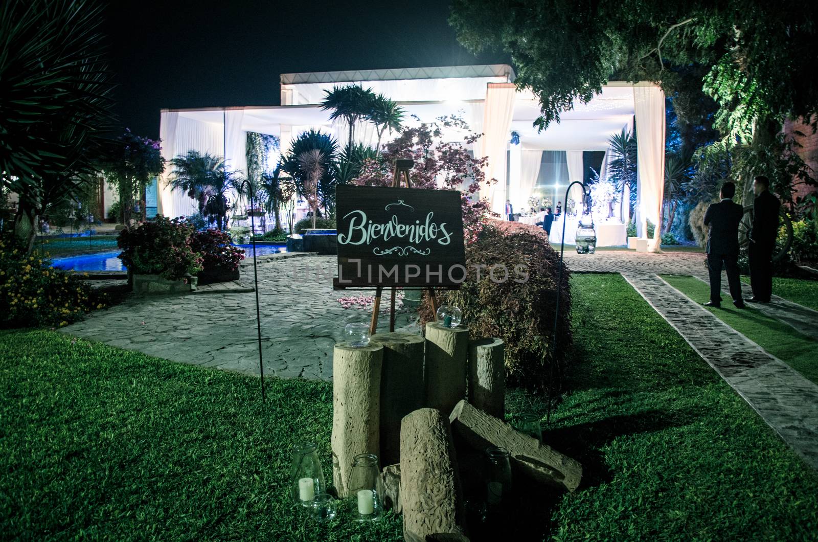 The wedding ceremony at night, with a sign that says Welcome