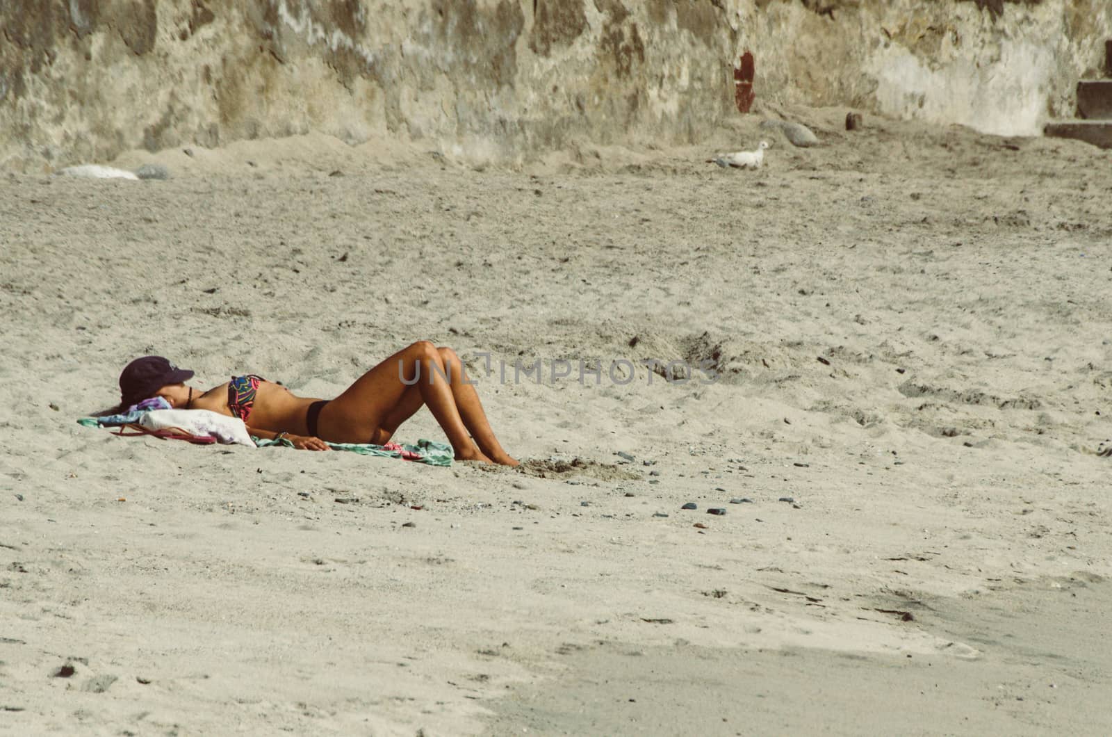 Young woman resting on the paradise beach and take sunbath