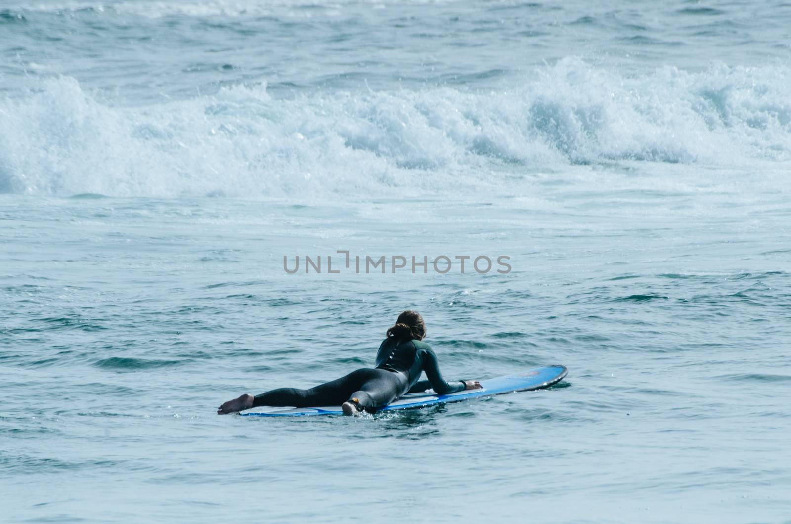 A beautiful girl at the beach with her bodyboard