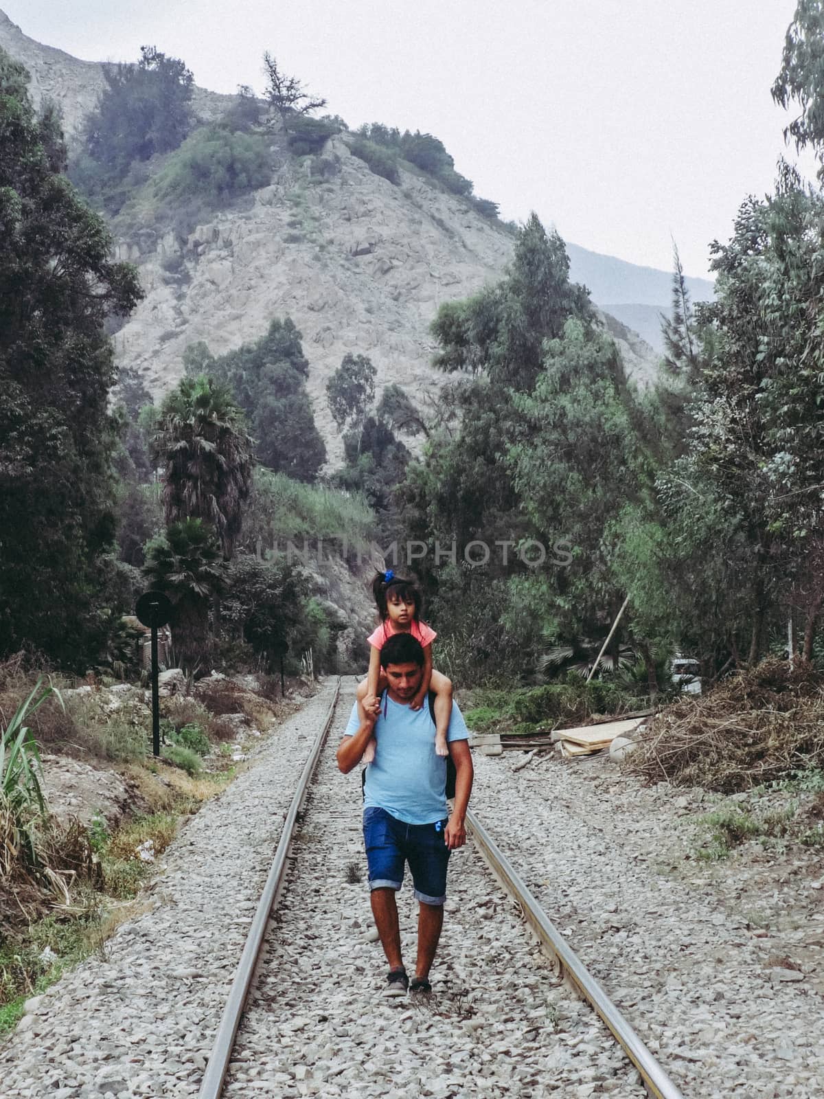 Father and daughter walking on the train tracks, father and daughter together