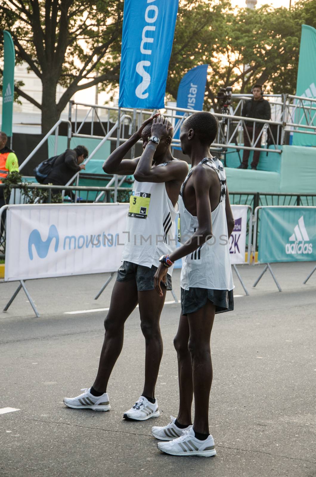 Lima, Peru - May 20th 2018: Marathon Lima 42k, sporting event that gathers athletes from all over the world. Elite athletes stretching before the marathon.