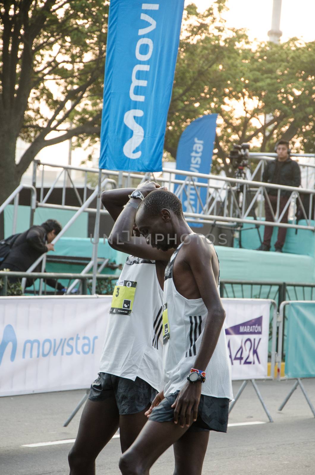 Lima, Peru - May 20th 2018: Marathon Lima 42k, sporting event that gathers athletes from all over the world. Elite athletes stretching before the marathon.