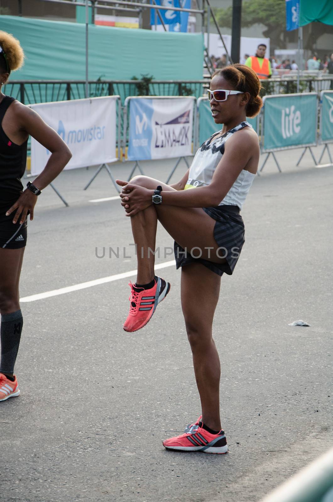 Lima, Peru - May 20th 2018: Marathon Lima 42k, sporting event that gathers athletes from all over the world. Elite athletes stretching before the marathon.