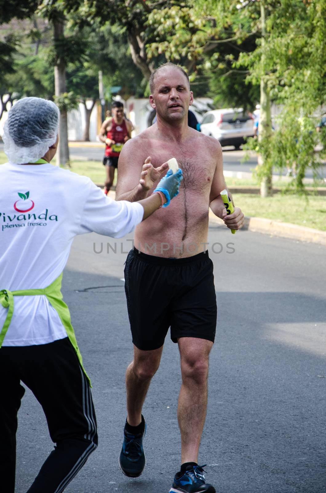 Lima, Peru - May 20th 2018: Marathon Lima 42k, sporting event that gathers athletes from all over the world. Athletes recovering energy with some foods