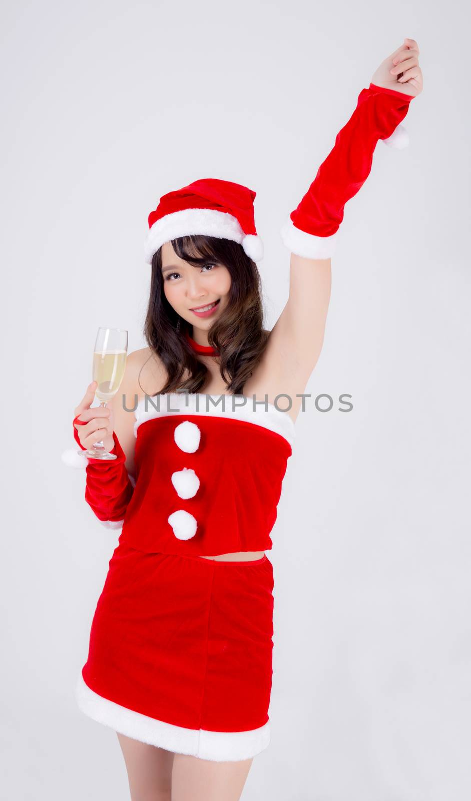 Beautiful portrait young asian woman in Santa holding glass of c by nnudoo