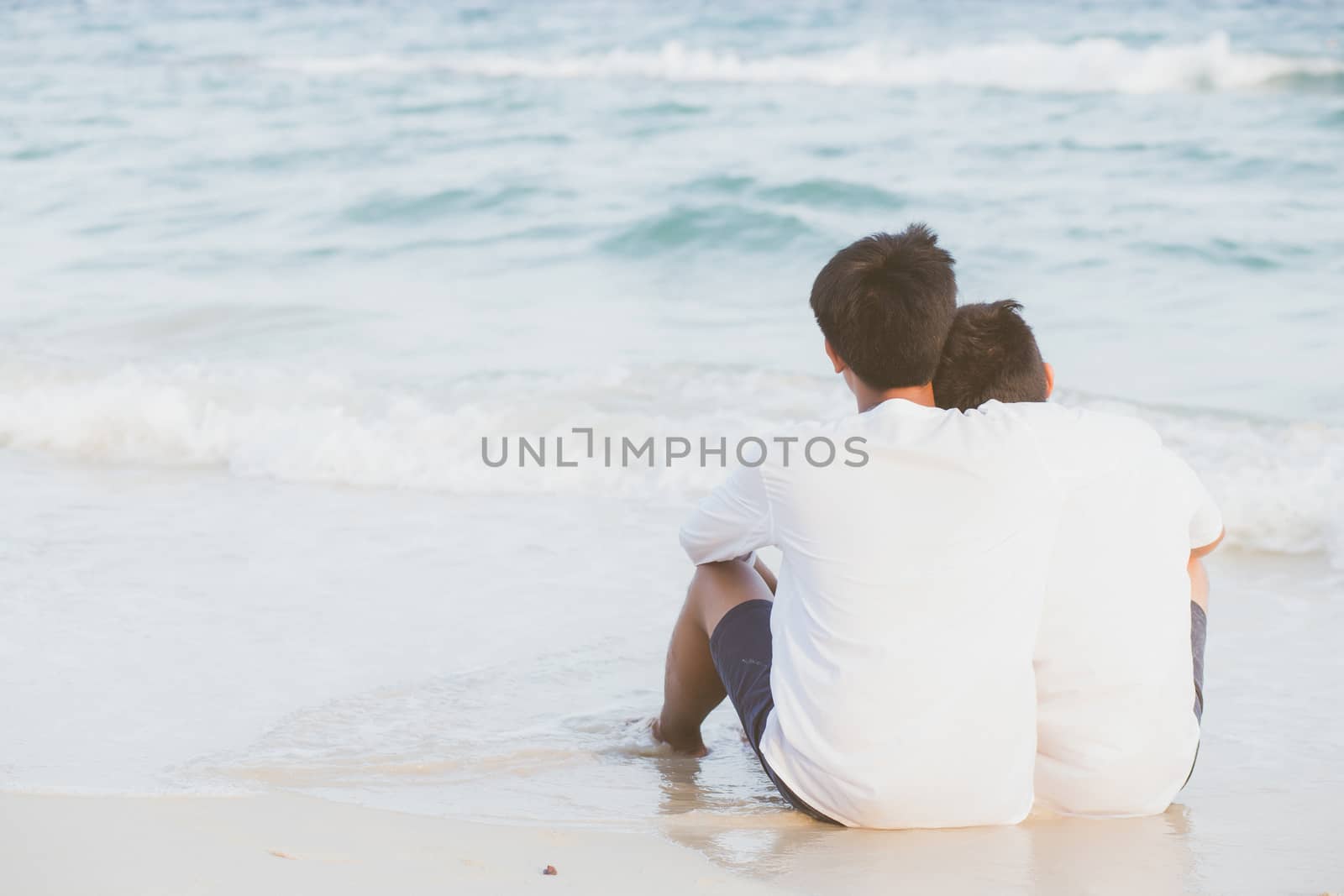 Back view homosexual portrait young asian couple sitting hug tog by nnudoo