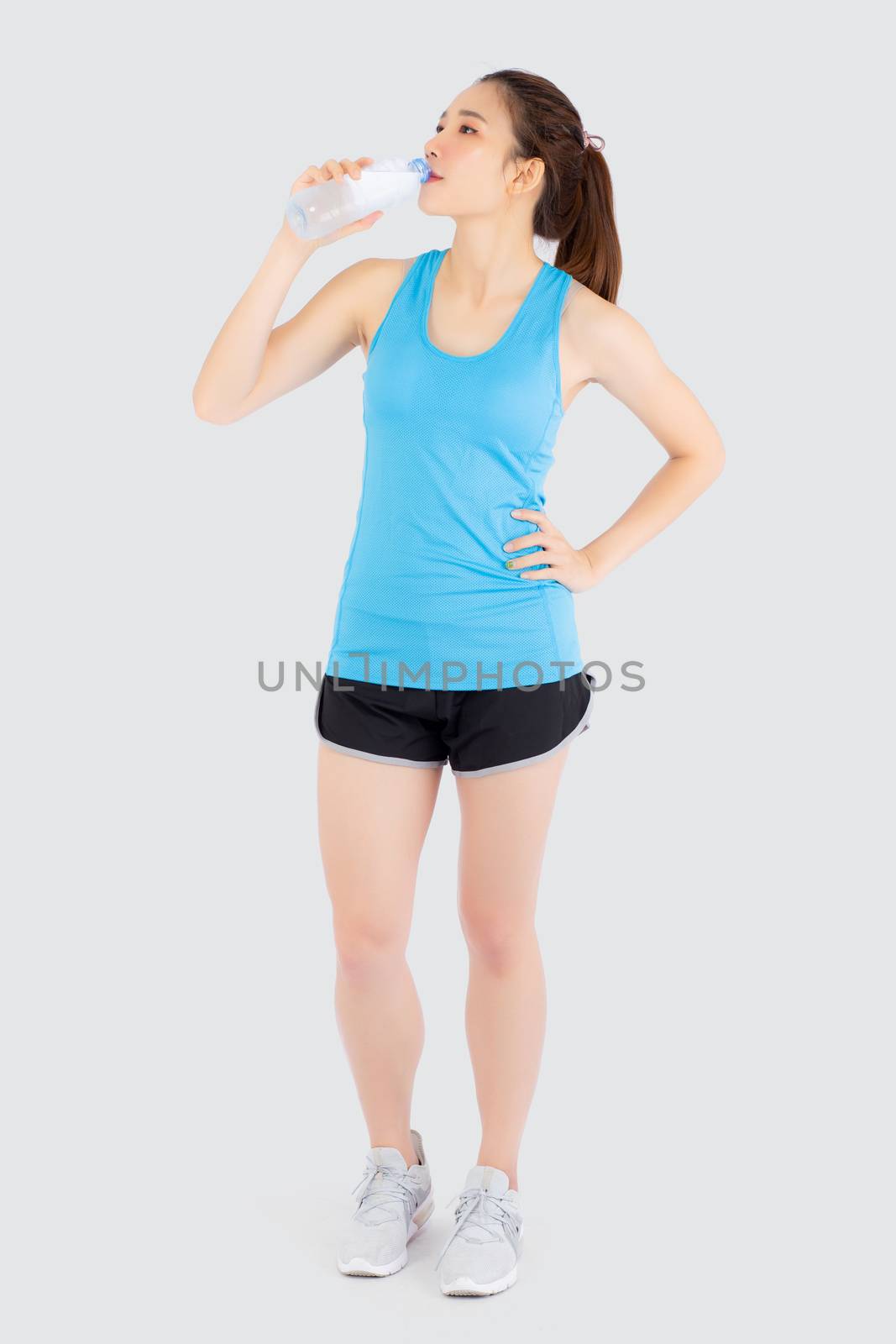 Beautiful young asian woman fit shape drinking water after workout and exercise isolated on white background, girl thirsty after aerobic tired for refresh, model fitness healthy and wellness concept.