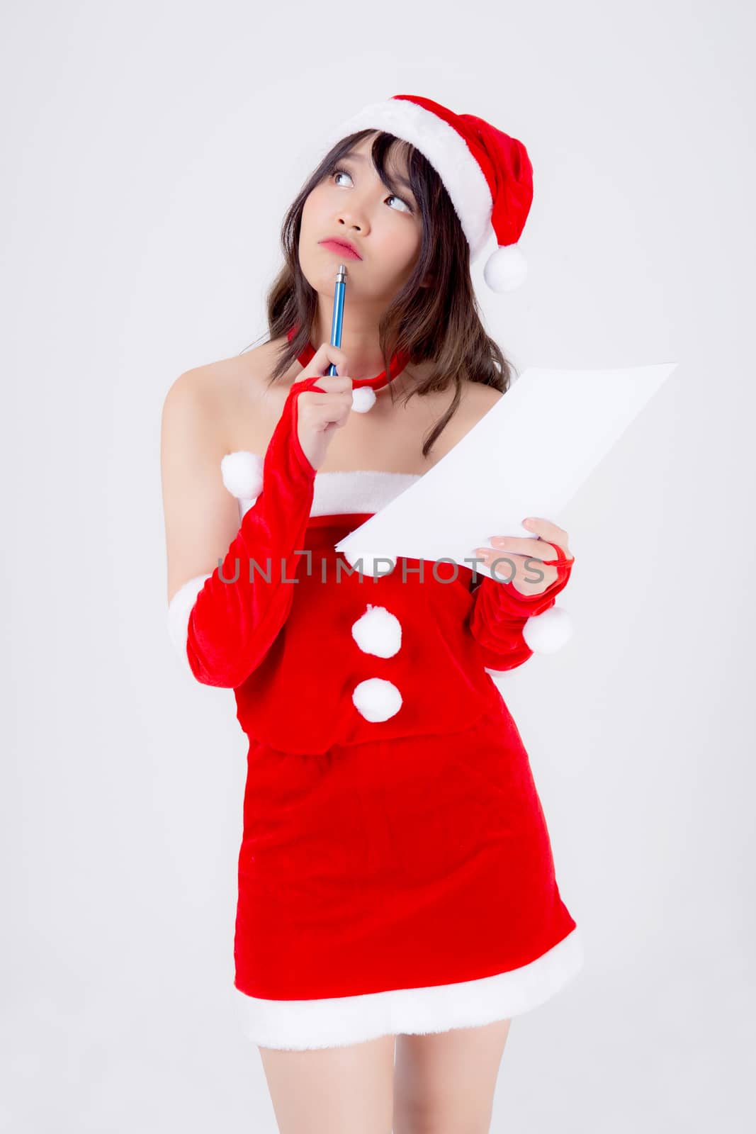 Beautiful portrait young asian woman thinking and writing notepad in xmas day isolated on white background, beauty asia girl think and list shopping or wish for celebrating in Christmas holiday.