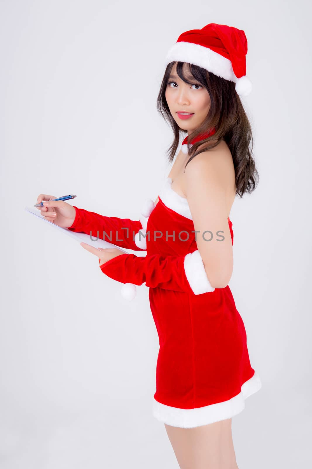Beautiful portrait young asian woman writing notepad in xmas day by nnudoo