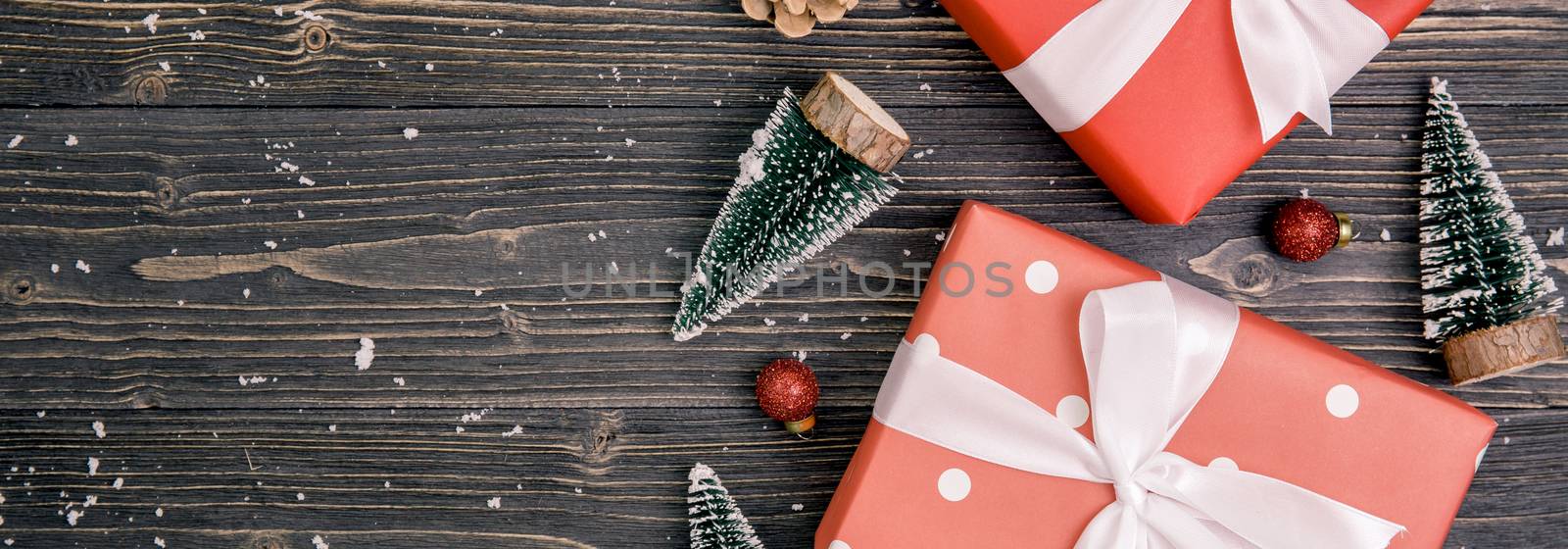 Christmas holiday composition with red gift box decoration on wooden background, new year and xmas or anniversary with presents on wood table in season, top view or flat lay, banner website.