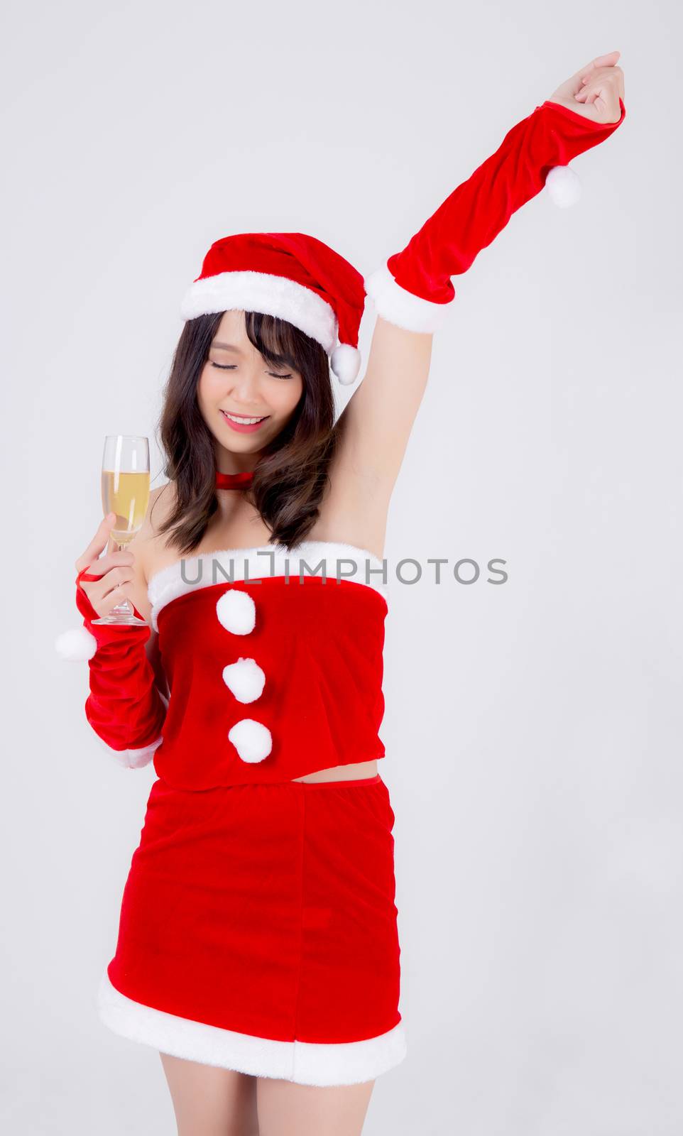 Beautiful portrait young asian woman in Santa holding glass of c by nnudoo