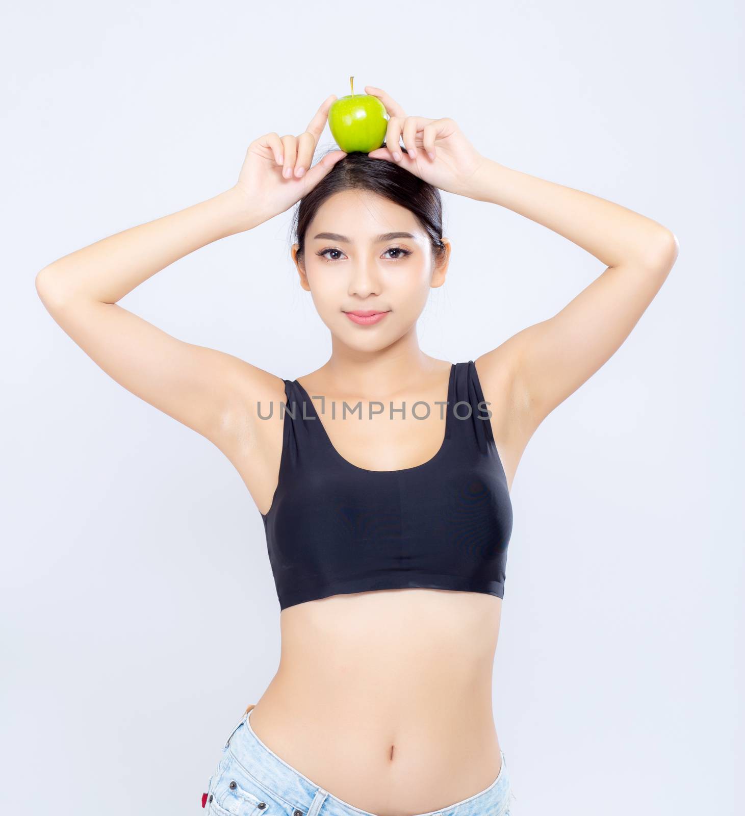 Beautiful portrait asian woman smiling holding green apple fruit by nnudoo