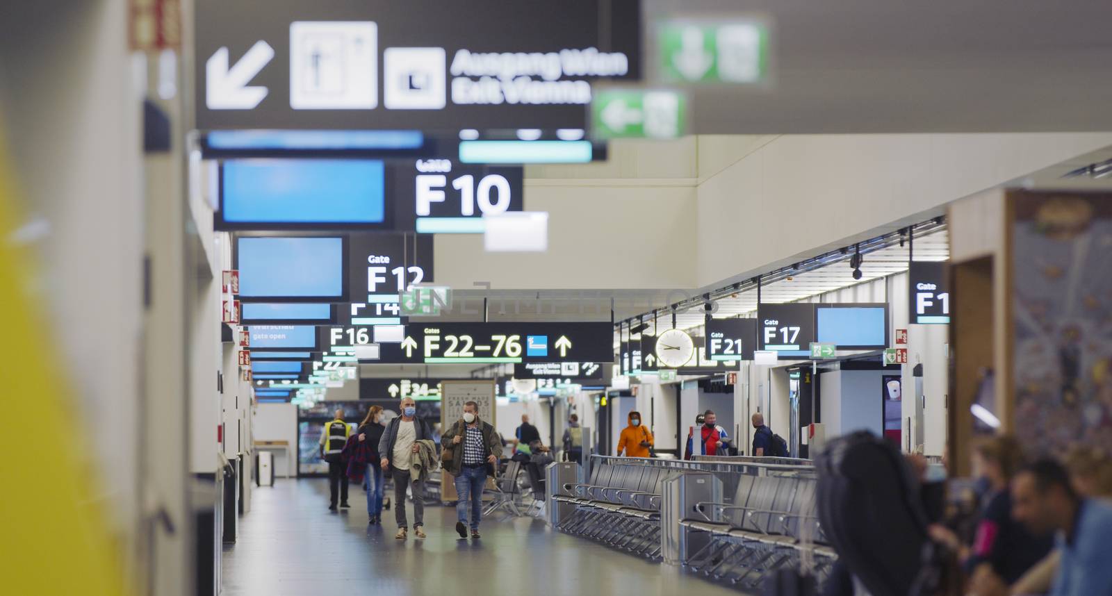 Vienna, Vienna/Austria - November 2nd 2020: Passengers walking to departure gates at Vienna airport. Only a few people travelling and a lot of closed gates.