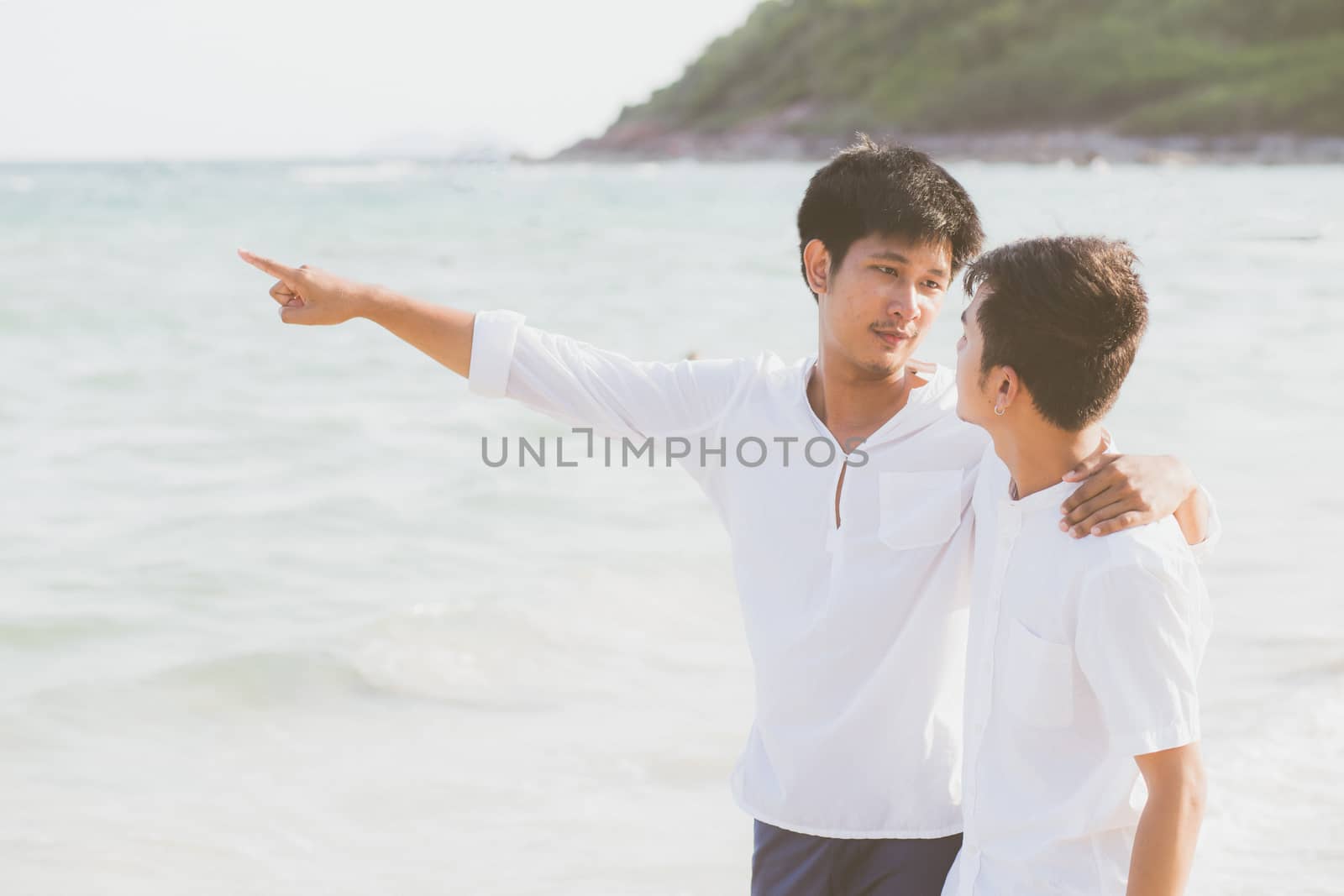 Homosexual portrait young asian couple standing pointing somethi by nnudoo