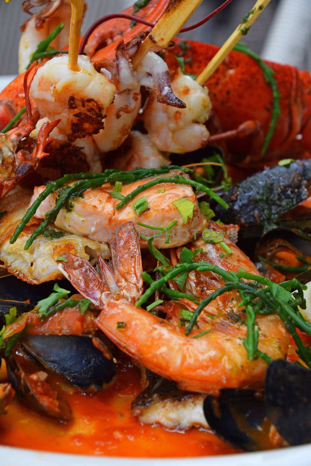 Close up large grilled seafood platter on table, low angle view