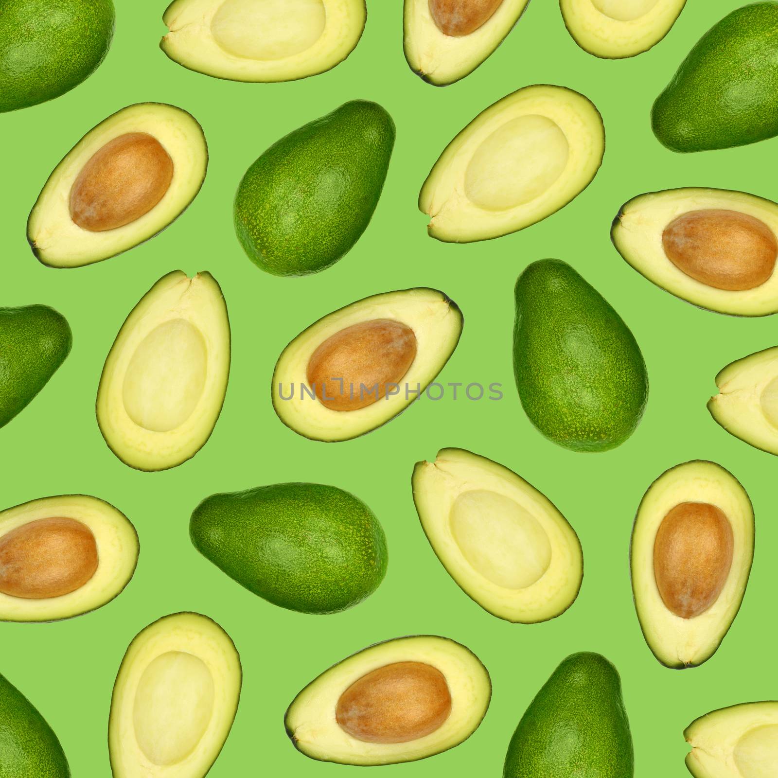 Pattern of fresh halved cut and whole avocados over green background