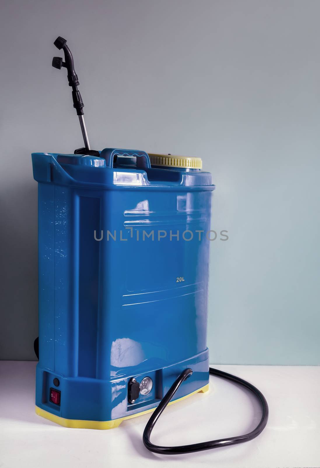 Backpack battery sprayer for protecting trees and plants from diseases and pests. The pressure is increased using a battery-powered pump. Close-up, copy space