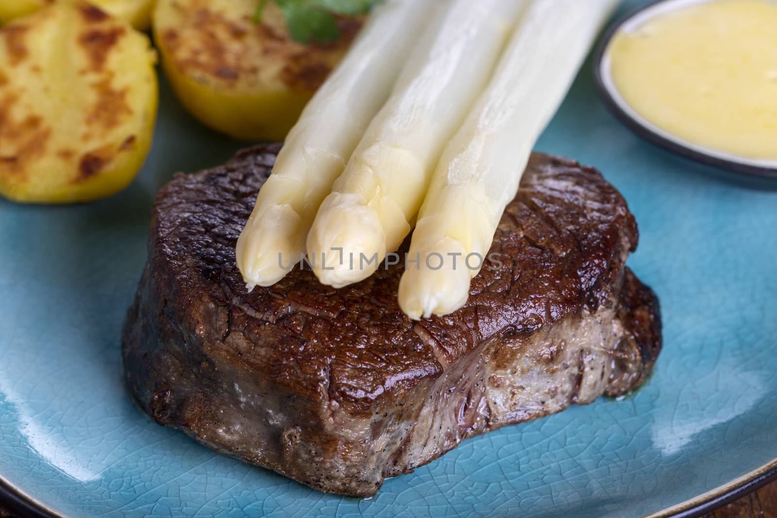 asparagus with potatoes and a steak