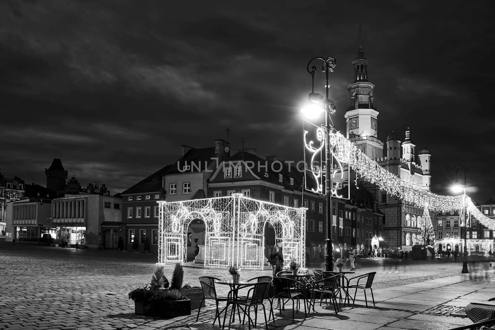 historic tenement houses and the renaissance town hall with Christmas decorations on the market square at night by gkordus