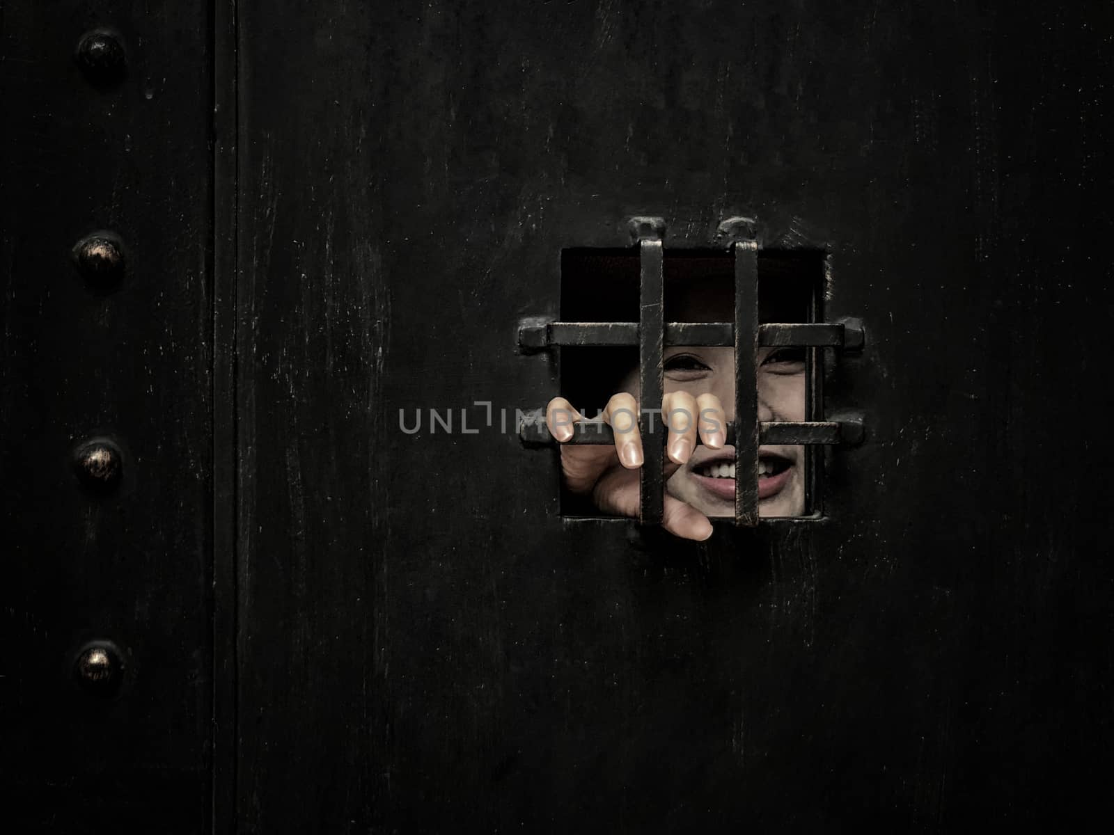 Horror woman locked in dark cage hand holding cage scary scene halloween concept