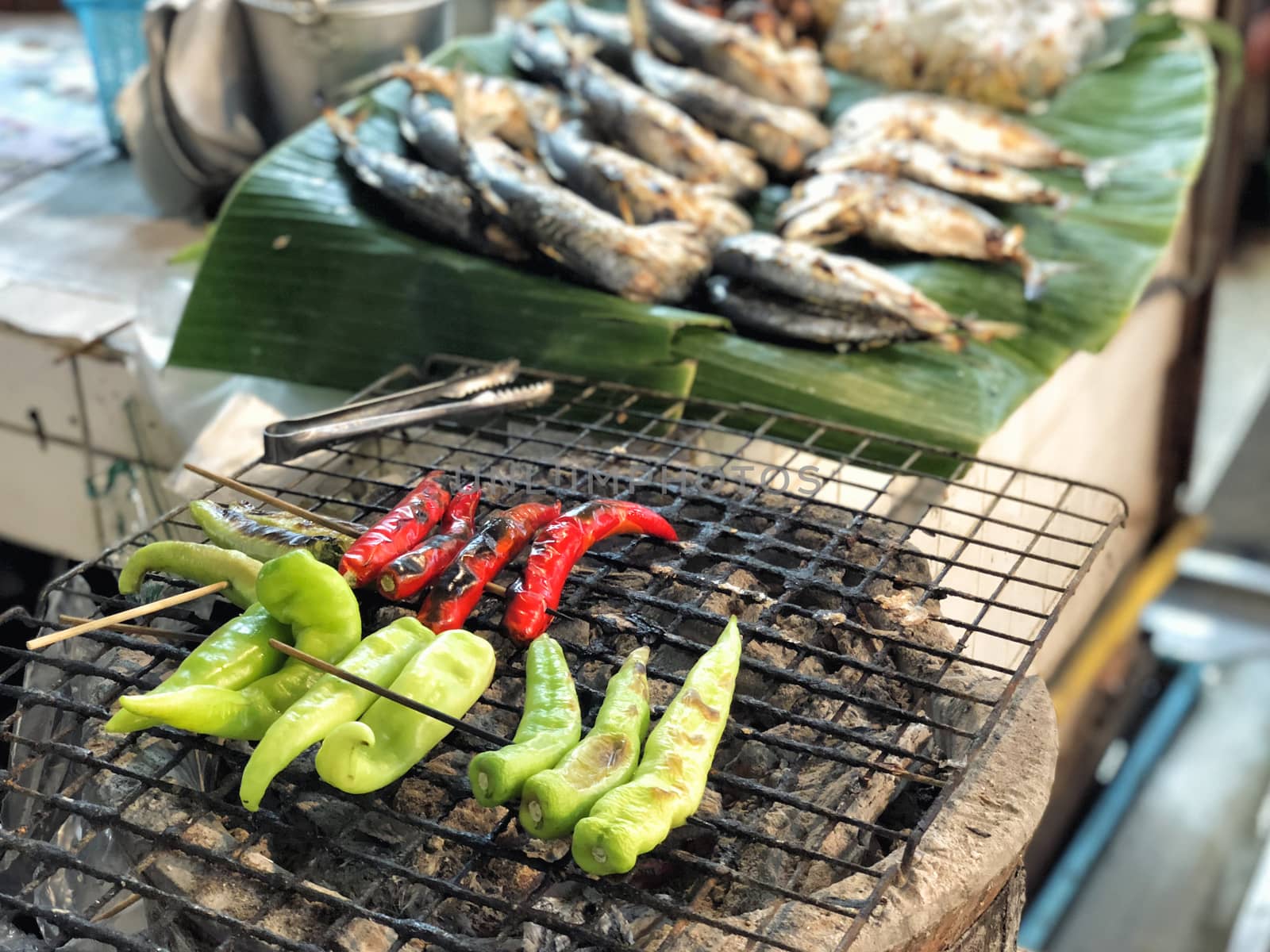 Bell pepper grill on stove in street market by Surasak