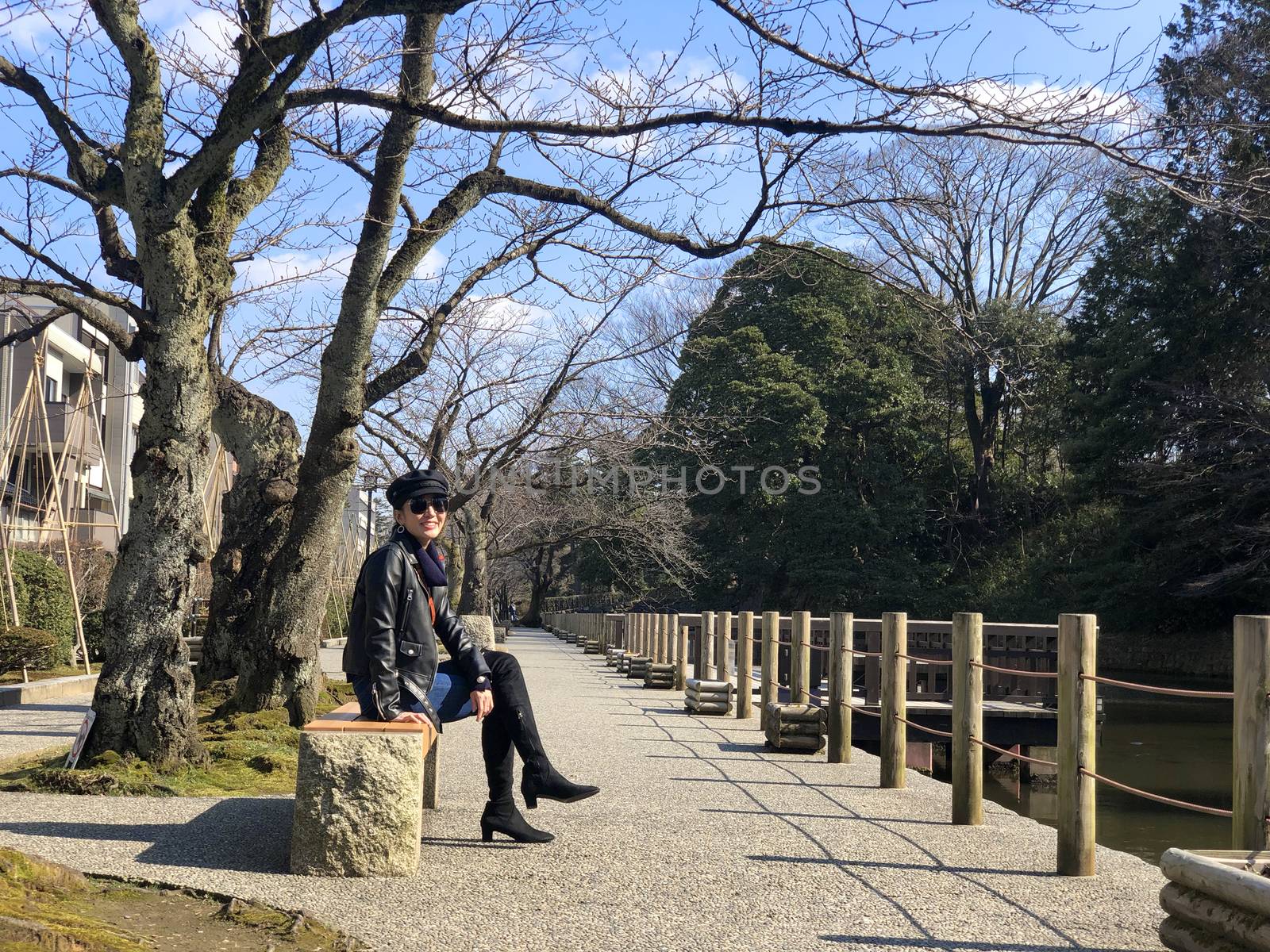 Woman sitting and seeing view around Kenrokuen garden and Kanaza by Surasak