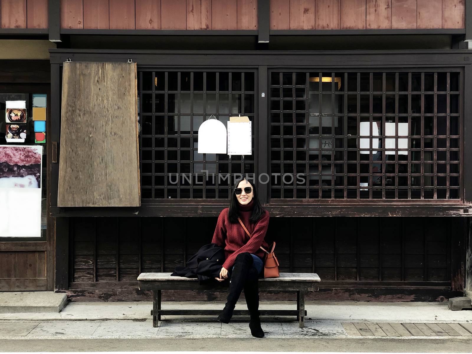 Happy woman tourist enjoy view in old twon street city of Takayama, Japan