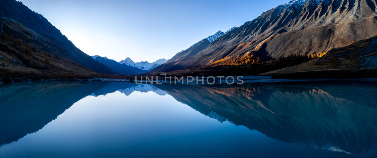 Lake in the Altai Mountains. Panorama of the Altai landscape in the mountains. The time of year is autumn.