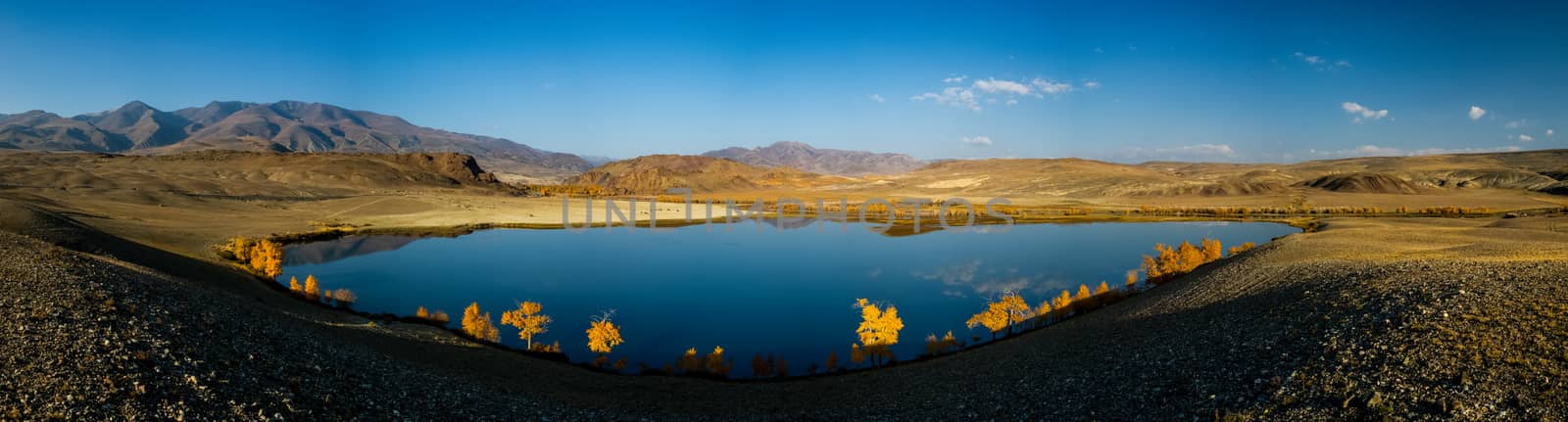 Lake in the Altai Mountains. Panorama of the Altai landscape in the mountains. The time of year is autumn.