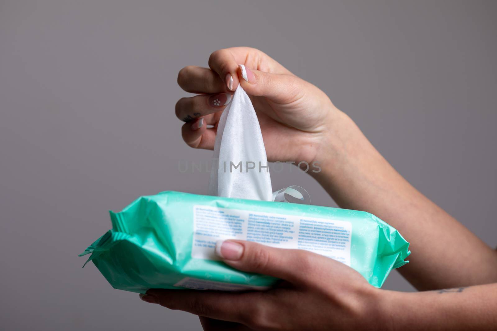 Taking baby wet wipes from the packaging - hygiene procedure and by adamr