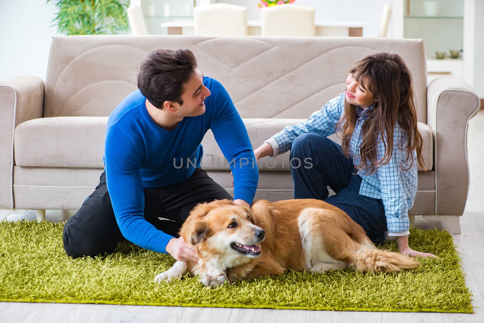 Happy family with golden retriever dog