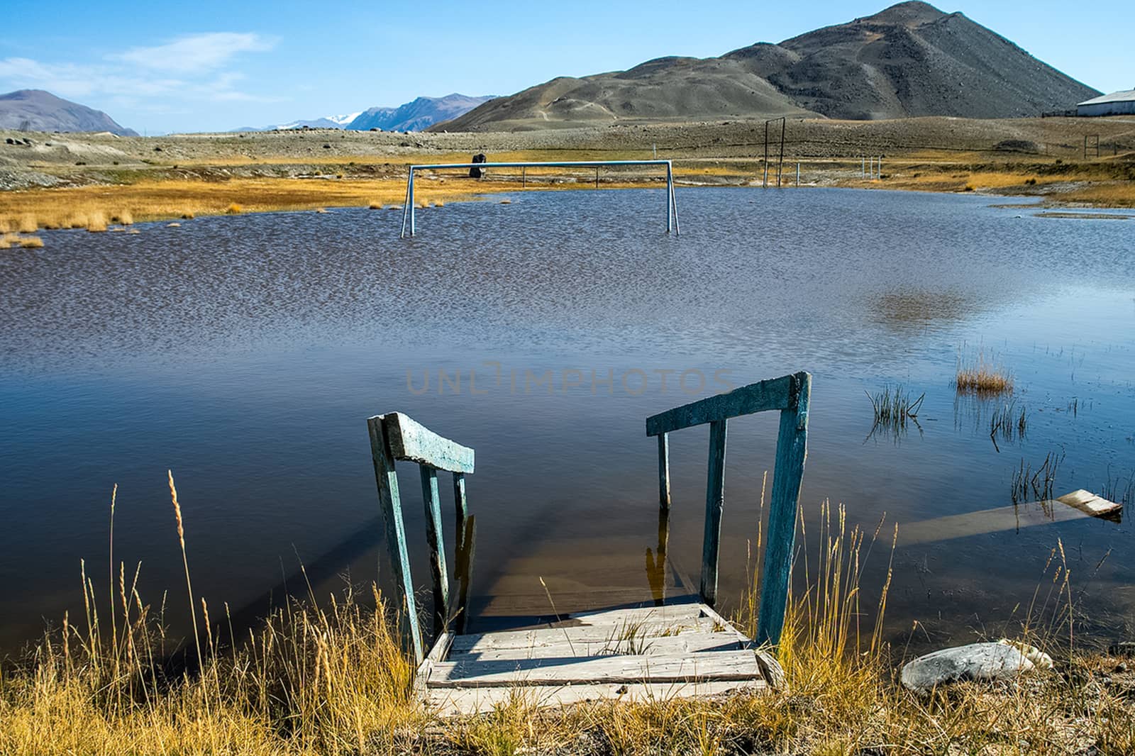 An old broken pier on the shore of the lake. Altai.