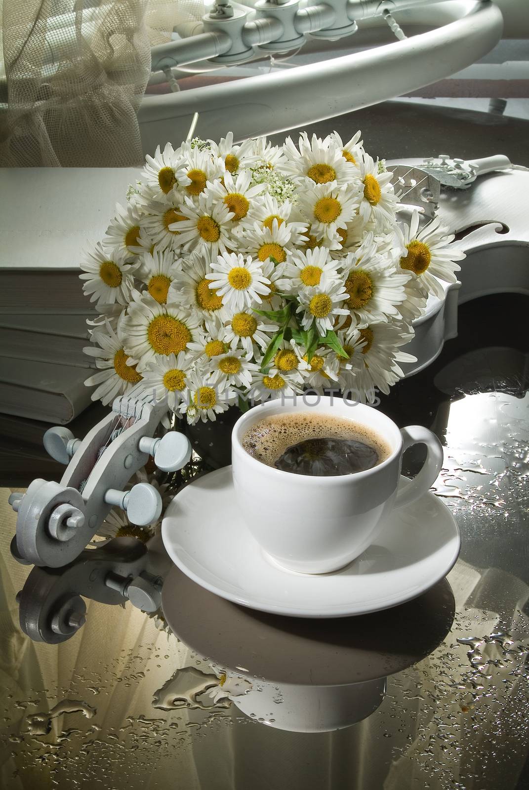 Cup of coffee and violin on a glass background