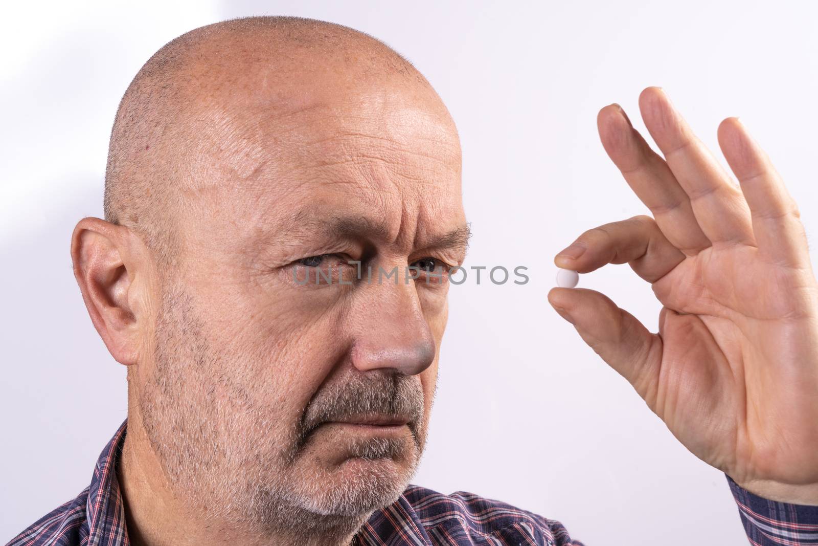 a man in pain with a pill in the hand