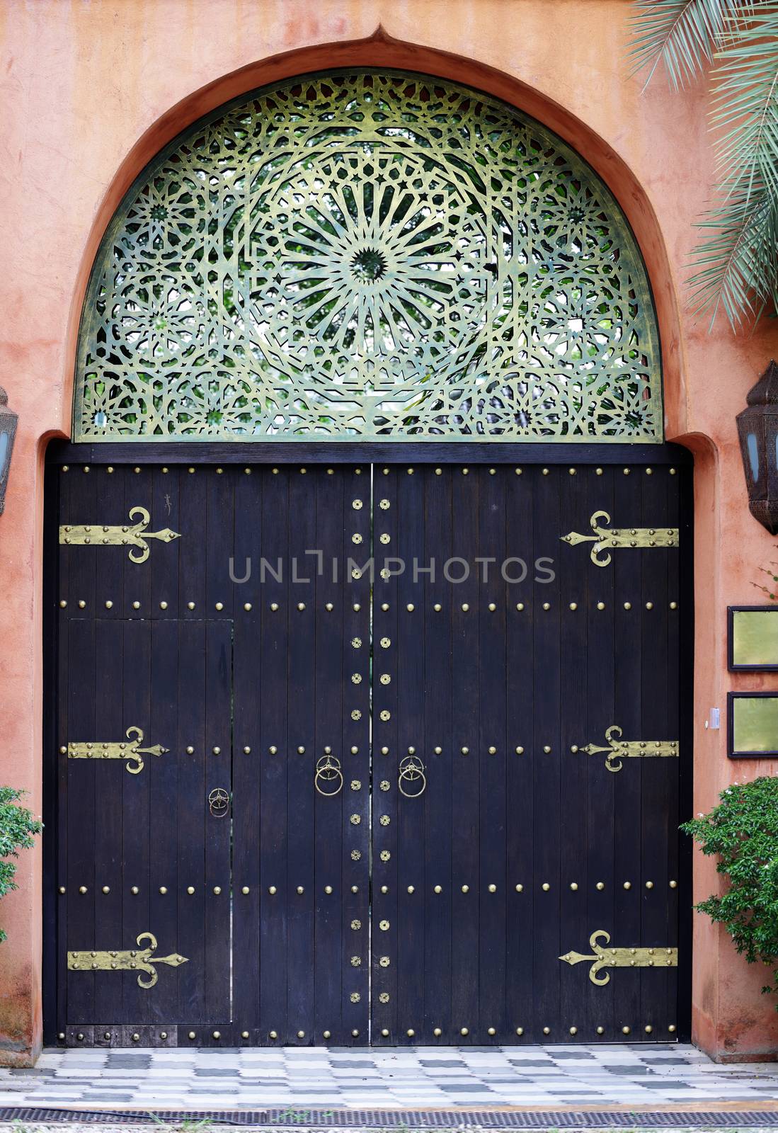 Bronze and wooden ornate Moccocan style closed front door entrance.